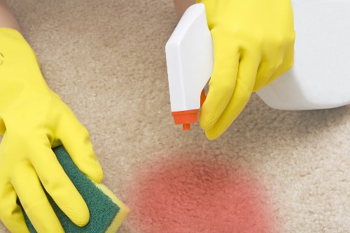 Cleaner carrying out a safe cleaning task with caution signage