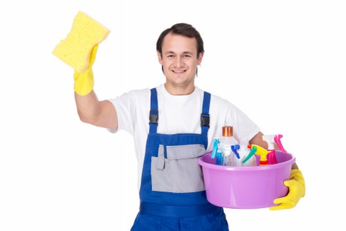 Cleaner using protective gloves during a professional cleaning task in Clapham