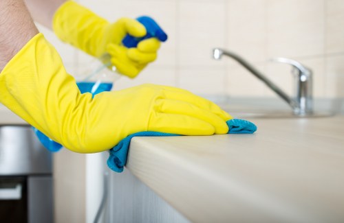 Cleaner performing a thorough one off cleaning service in Clapham kitchen